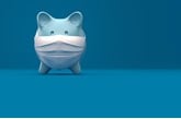  Piggy Bank Wearing A Surgical Mask over blue background. covid-19