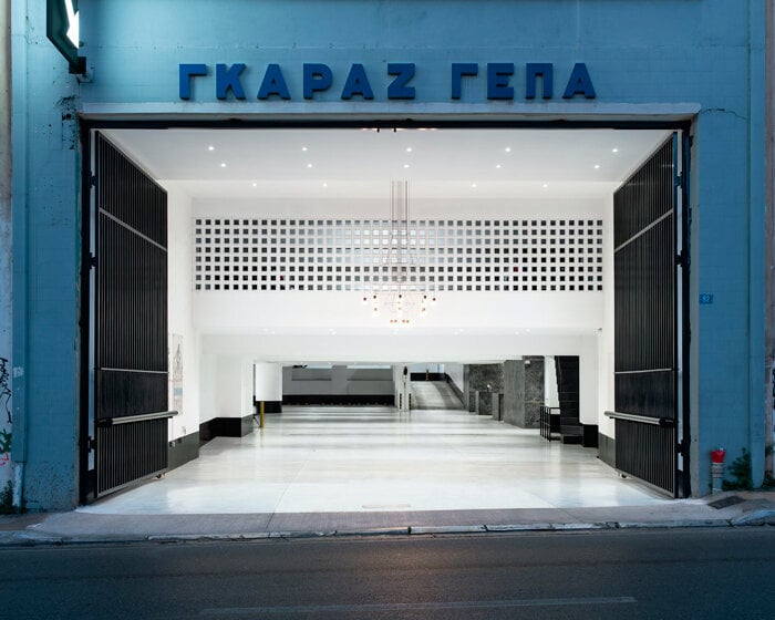 parking garage's black marble reception in central athens features brass details